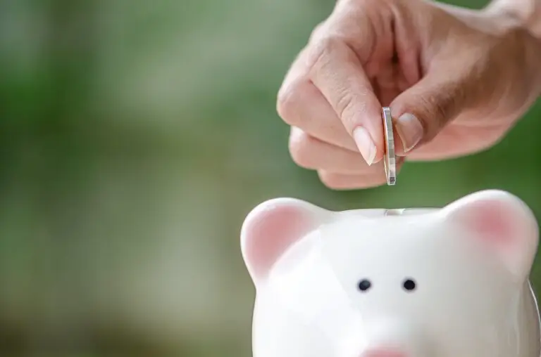 piggy bank for investment ,save money or retire in future with blue background and copy space